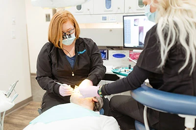 Dr. and assistant working on a patient at Anderson Family Dentist