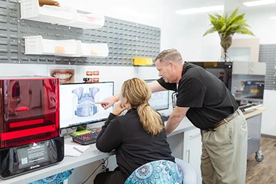 Dr. Anderson and dental assistant looking at a patient scan